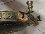 a gold and green vase with a bird on it