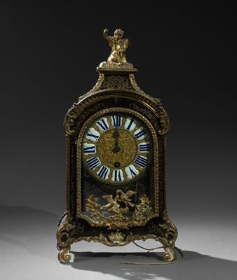 a clock that is sitting on a stand with a bird on it