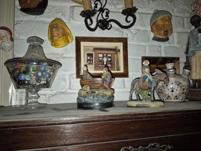 a dresser with a bunch of vases on top of it