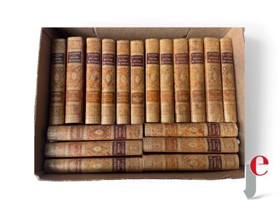 a box filled with old books sitting on top of a white surface