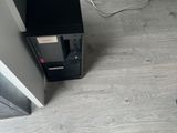 a black and silver vacuum on the floor next to a wall