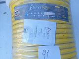 a large coil of yellow hose sitting on the ground
