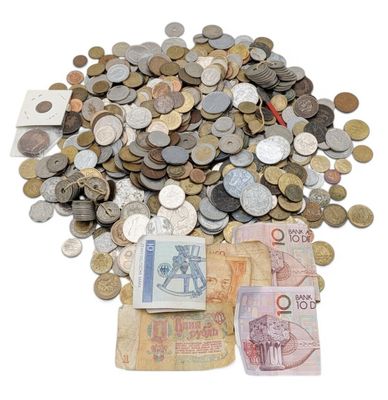 a pile of money sitting on top of a pile of coins