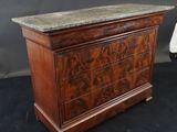 an antique chest of drawers with marble top
