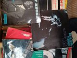a lot of records in a cardboard box on the floor