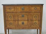 a small wooden chest of drawers with a marble top
