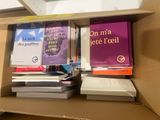 many books in the box on the shelf