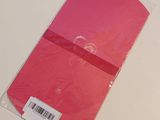 a pink envelope that has a sticker on it