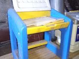 a blue and yellow desk with a laptop on it