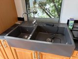 two sinks in the kitchen that are connected to the faucet