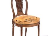 a wooden chair with a floral upholstered seat