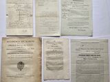 several old papers are sitting on a table with a white background