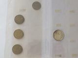 some coins are in a clear plastic bag on a white surface