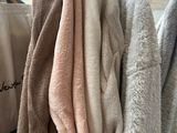 many towels hanging on a rack in a store