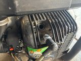 a close up of a motorcycle engine with a hose attached to it