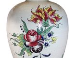 a white vase with a red flower on it