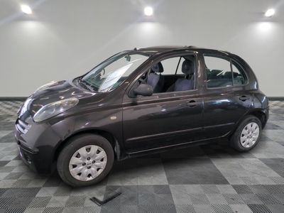 a small car that is parked on a checkered floor