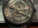 a close up of a wrist watch on a desk