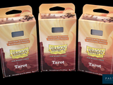 three boxes of tarot sitting on top of each other on a black surface