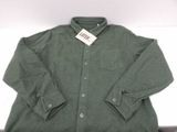shirt is green and has a tag on the collar