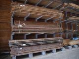 several stacks of wooden planks are stacked up in a warehouse