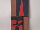 two pieces of cardboard are stacked on top of each other on a white surface