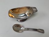 two spoons that are sitting next to each other on a table