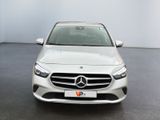 the front view of a white mercedes cla parked in a garage