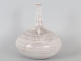 a white vase that is sitting on a table