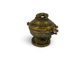 a gold and black urn with a dragon on it