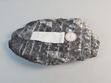a rock with a sticker on it sitting on a table