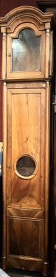 a tall wooden cabinet with a mirror on top of it