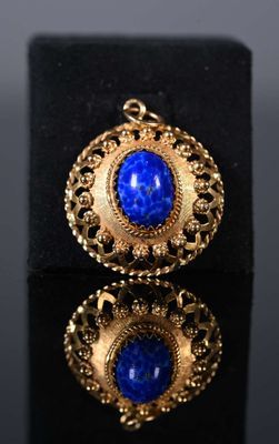 un gros plan sur une paire de boucles d'oreilles en or et en lapis-lazuli
