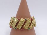 a close up of a gold bracelet on top of a cone