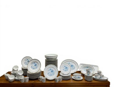 a wooden table with a bunch of plates and bowls on it