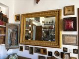 a picture of a living room with a lot of pictures on the wall