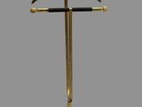 a gold and black coat rack with a wooden hanger on it