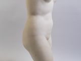 marble statue of a female nude torso on a marble base
