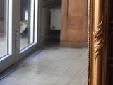 a mirror that is sitting on the floor in front of a door