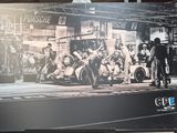 a black and white photo of a man riding a motorcycle on the street