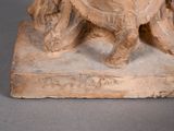 a statue of a man riding a horse on a stone base