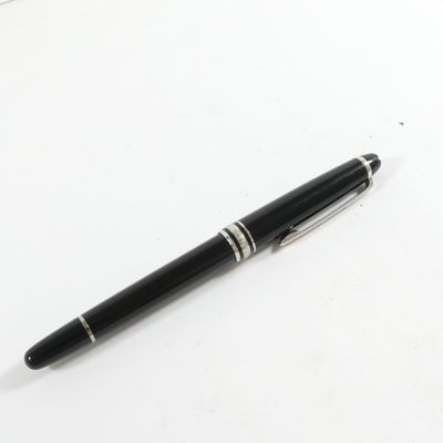 un stylo noir posé sur une table blanche