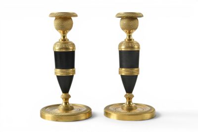 pair of black and gold candlesticks on a white background