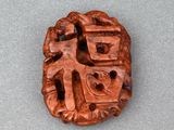 a close up of a small carved object on a table