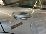 a close up of a car door handle with a sticker on it