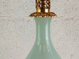 a glass lamp that is sitting on a table