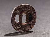 a small piece of metal with a design on it