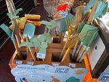 a wooden box filled with different types of brooms