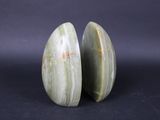 two pieces of green jade on a black background