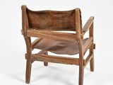 a wooden chair with a brown leather seat on a white background